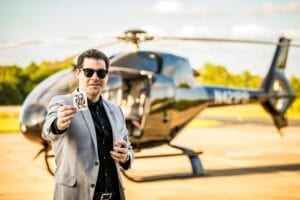 Bentley Burns Magician with a helicopter in Madison Mississippi holding a playing card