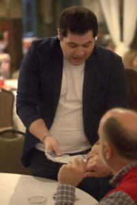 Bentley Burns performing close-up magic during a corporate event